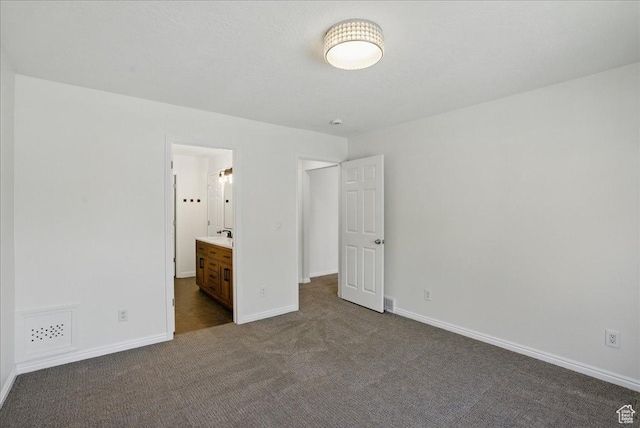 5167 N Rodeo Cir Unit 6, Oakley, UT 84055 - unfurnished bedroom with dark carpet, baseboards, and ensuite bathroom