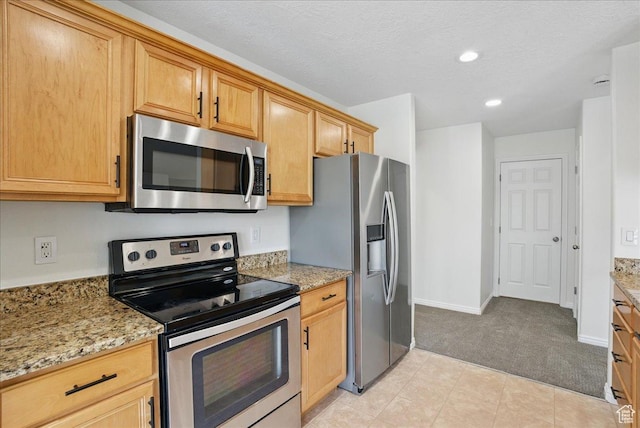 5167 N Rodeo Cir Unit 6, Oakley, UT 84055 - kitchen featuring stainless steel appliances, light colored carpet, recessed lighting, baseboards, and light stone countertops