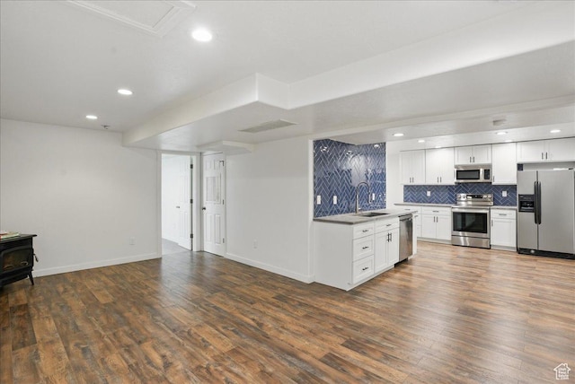5167 N Rodeo Cir Unit 6, Oakley, UT 84055 - kitchen featuring appliances with stainless steel finishes, a sink, open floor plan, tasteful backsplash, and dark wood-style floors