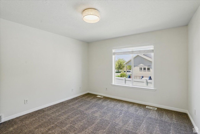 5167 N Rodeo Cir Unit 6, Oakley, UT 84055 - spare room featuring dark carpet and baseboards