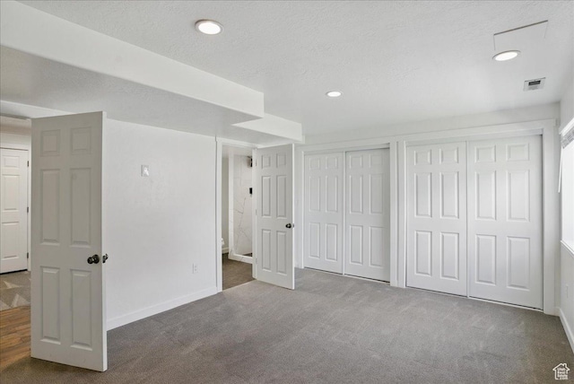 5167 N Rodeo Cir Unit 6, Oakley, UT 84055 - unfurnished bedroom with two closets, carpet floors, baseboards, recessed lighting, and a textured ceiling
