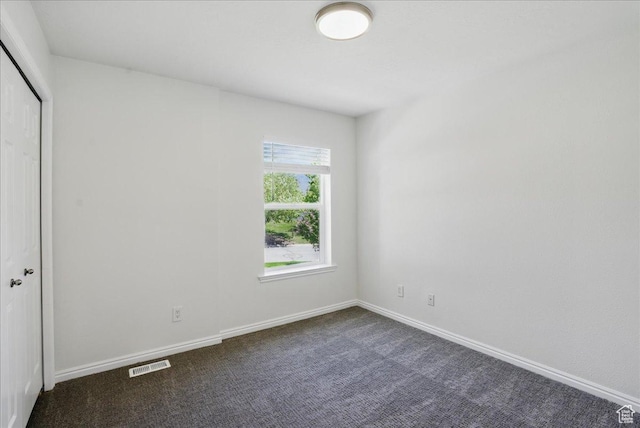 5167 N Rodeo Cir Unit 6, Oakley, UT 84055 - unfurnished bedroom with dark carpet, a closet, and baseboards
