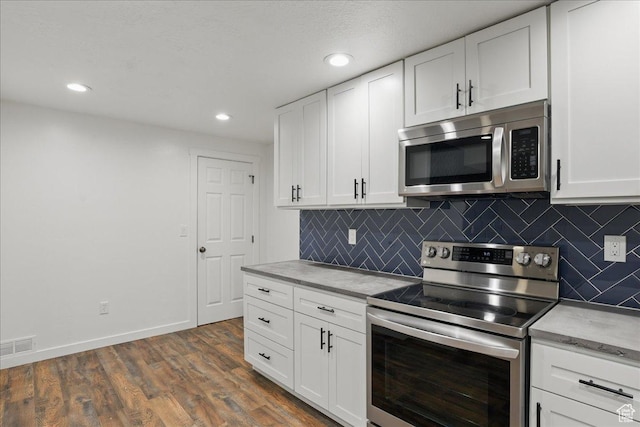 5167 N Rodeo Cir Unit 6, Oakley, UT 84055 - kitchen with appliances with stainless steel finishes, backsplash, white cabinetry, and recessed lighting