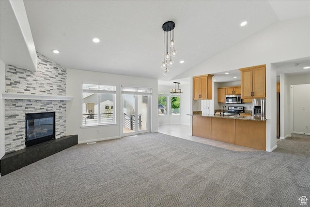 5167 N Rodeo Cir Unit 6, Oakley, UT 84055 - kitchen featuring stainless steel appliances, open floor plan, light colored carpet, vaulted ceiling, and hanging light fixtures