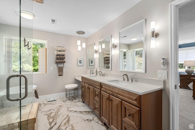 10927 S Lostwood Dr, Sandy, UT 84092 - full bathroom featuring marble look tiles, double vanity, a freestanding bath, and baseboards