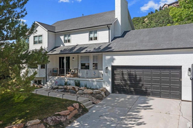 10927 S Lostwood Dr, Sandy, UT 84092 - traditional-style house with a porch, a garage, a chimney, concrete driveway, and a shingled roof