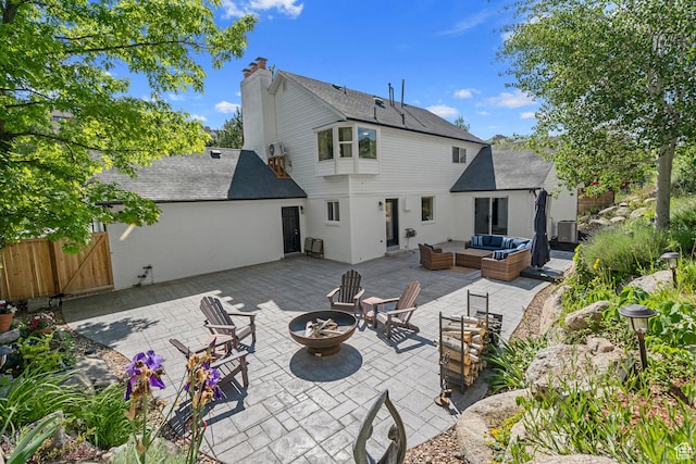 10927 S Lostwood Dr, Sandy, UT 84092 - rear view of house with an outdoor living space with a fire pit, a patio, a shingled roof, brick siding, and a gate