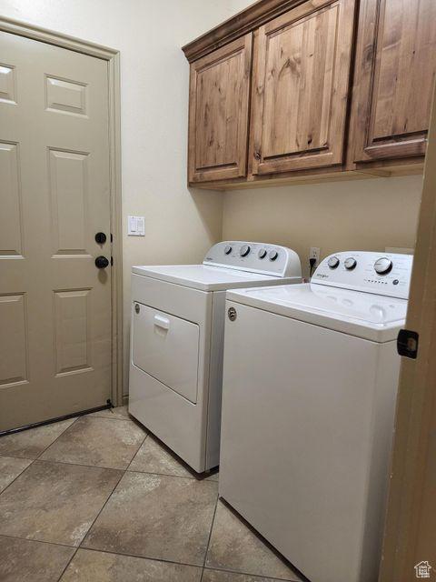 779 S 1850 W, Cedar City, UT 84720 - washroom featuring washer and clothes dryer, cabinet space, and light tile patterned floors