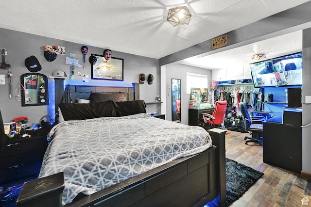 4825 S Burch Creek Dr E, South Ogden, UT 84403 - bedroom featuring hardwood / wood-style floors and a textured ceiling