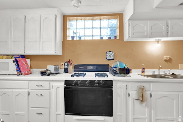 4825 S Burch Creek Dr E, South Ogden, UT 84403 - kitchen with range with gas cooktop, a sink, white cabinets, and light countertops