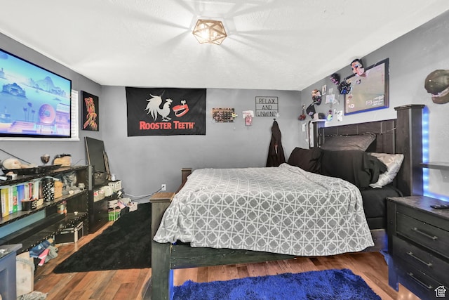4825 S Burch Creek Dr E, South Ogden, UT 84403 - bedroom with wood finished floors and a textured ceiling