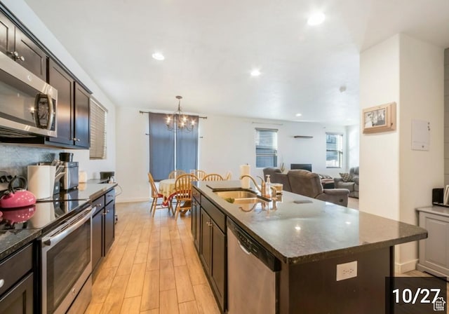269 W Willow Dr, Saratoga Springs, UT 84045 - kitchen with appliances with stainless steel finishes, a sink, light wood-style floors, dark brown cabinetry, and a chandelier