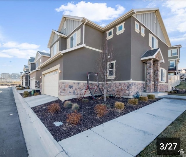 269 W Willow Dr, Saratoga Springs, UT 84045 - view of home's exterior featuring board and batten siding, stone siding, and an attached garage