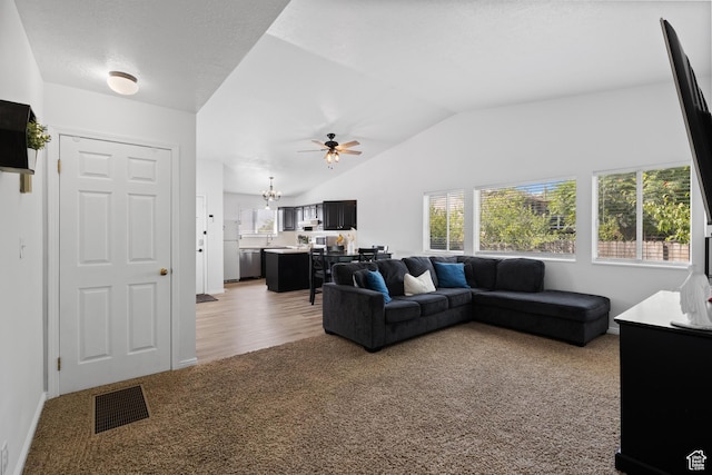 429 S Storrs Ave, American Fork, UT 84003 - living area with light colored carpet, vaulted ceiling, a ceiling fan, and a chandelier