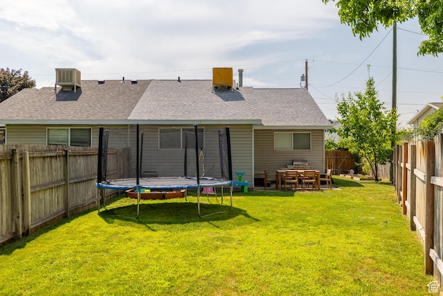 429 S Storrs Ave, American Fork, UT 84003 - back of property with a trampoline, roof with shingles, and central AC unit