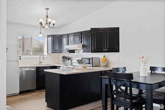 429 S Storrs Ave, American Fork, UT 84003 - kitchen featuring stainless steel appliances, a sink, light countertops, lofted ceiling, and a peninsula