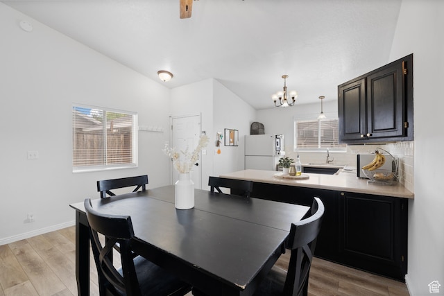 429 S Storrs Ave, American Fork, UT 84003 - dining space featuring a chandelier, light wood-type flooring, baseboards, and lofted ceiling