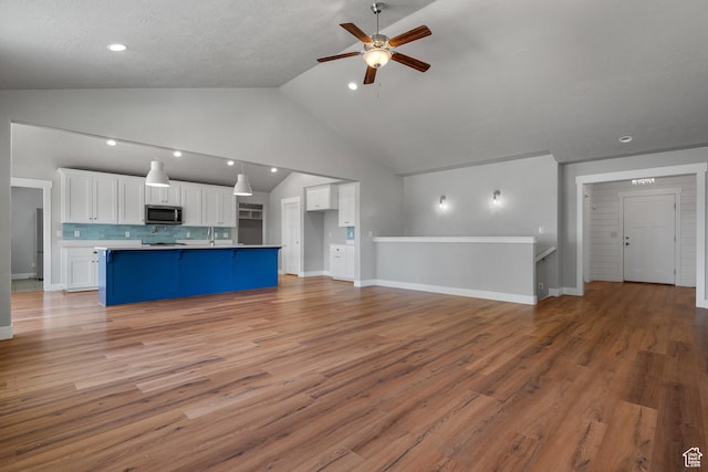 1047 N 700 W, Mapleton, UT 84664 - unfurnished living room with a ceiling fan, light wood-style floors, recessed lighting, baseboards, and a sink