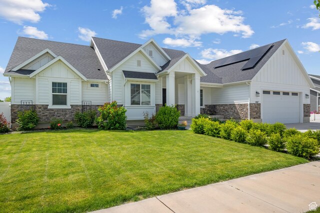 1047 N 700 W, Mapleton, UT 84664 - view of front of home featuring board and batten siding, stone siding, solar panels, and a shingled roof