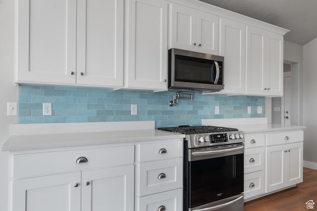1047 N 700 W, Mapleton, UT 84664 - kitchen with appliances with stainless steel finishes, light countertops, white cabinets, and tasteful backsplash