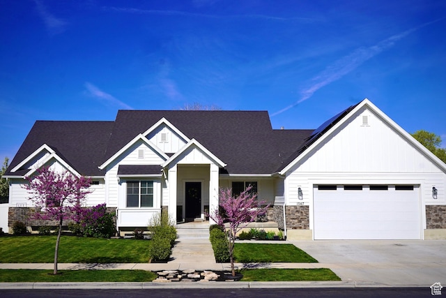 1047 N 700 W, Mapleton, UT 84664 - view of front of house featuring board and batten siding, stone siding, an attached garage, roof with shingles, and driveway