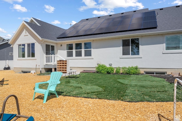 1047 N 700 W, Mapleton, UT 84664 - back of house featuring roof with shingles, roof mounted solar panels, stucco siding, and a yard