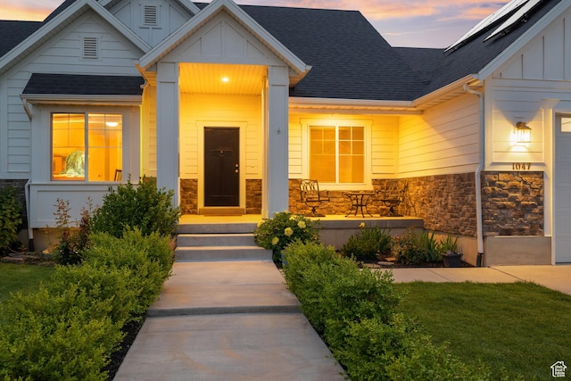 1047 N 700 W, Mapleton, UT 84664 - exterior entry at dusk with board and batten siding, stone siding, and roof with shingles