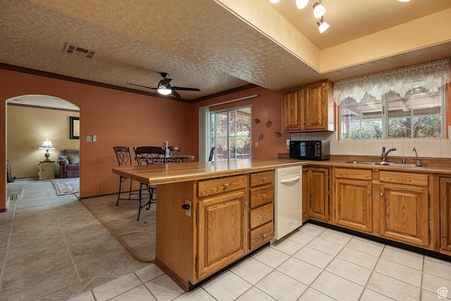 845 S 80 W, Hurricane, UT 84737 - kitchen featuring white dishwasher, black microwave, a sink, brown cabinetry, and a peninsula
