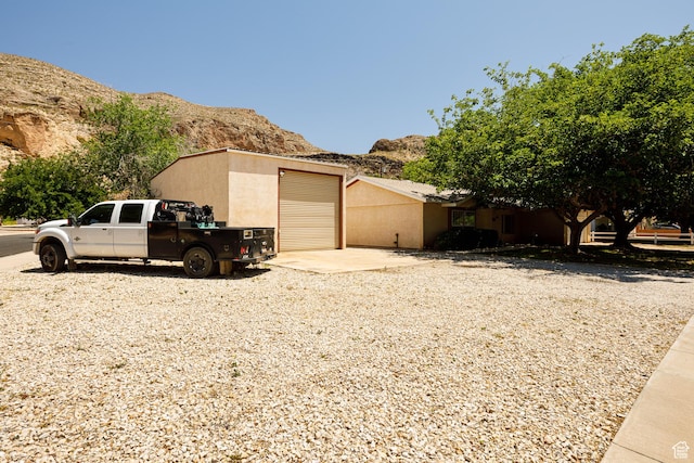 845 S 80 W, Hurricane, UT 84737 - view of property exterior with a mountain view, a garage, driveway, and stucco siding