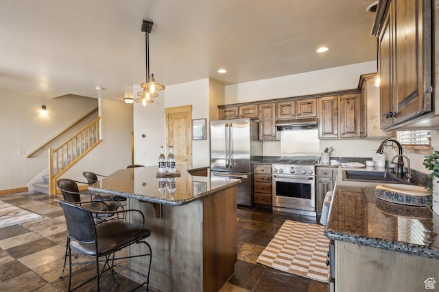 5430 N Cross Country Way, Park City, UT 84098 - kitchen featuring a sink, high quality appliances, a center island, a breakfast bar area, and dark stone countertops