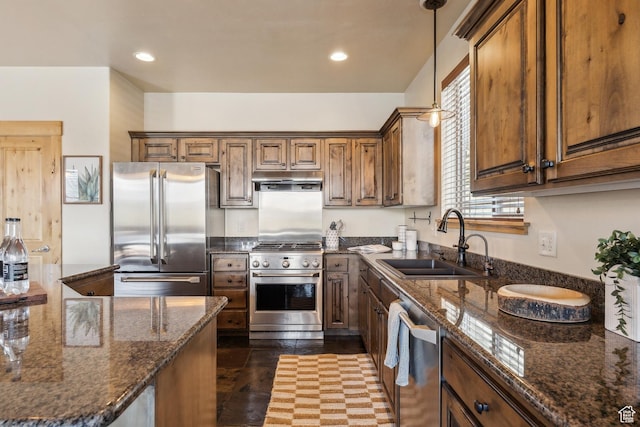5430 N Cross Country Way, Park City, UT 84098 - kitchen with high quality appliances, a sink, pendant lighting, dark stone countertops, and under cabinet range hood