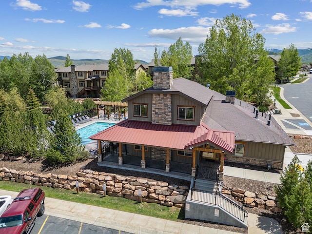 5430 N Cross Country Way, Park City, UT 84098 - view of front of house with a chimney, board and batten siding, stone siding, and a gate