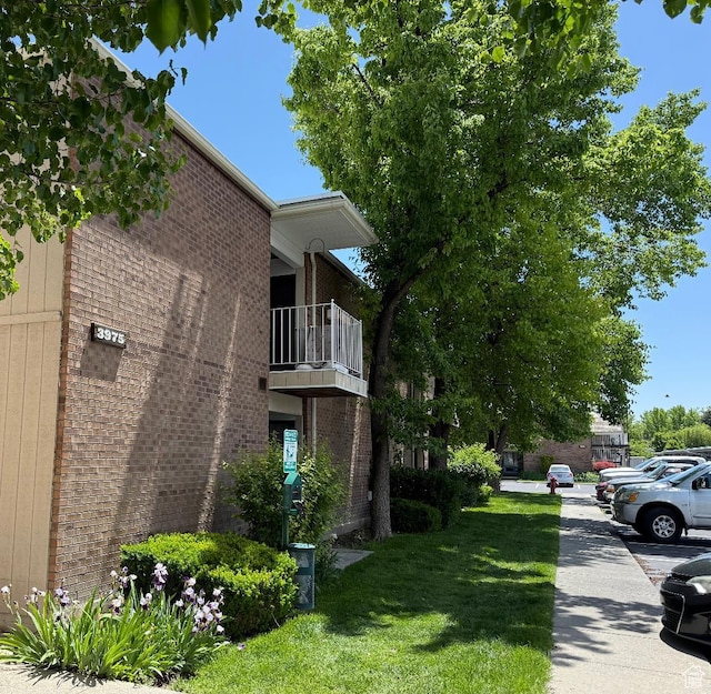 3975 S 805 E Unit G, Salt Lake City, UT 84107 - view of side of home with a balcony, brick siding, and a yard