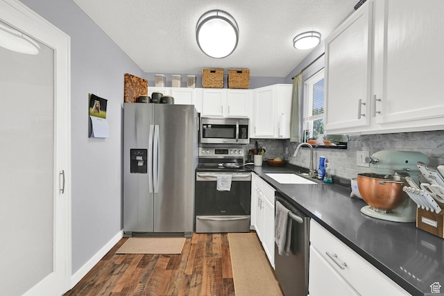 5443 S 4175 W, Roy, UT 84067 - kitchen featuring stainless steel appliances, a sink, dark countertops, dark wood finished floors, and backsplash