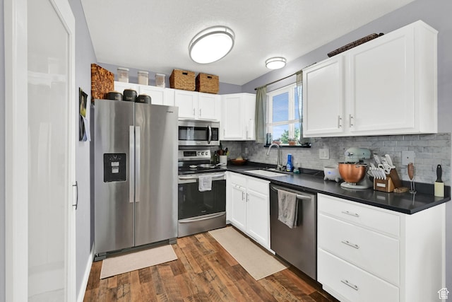 5443 S 4175 W, Roy, UT 84067 - kitchen with stainless steel appliances, dark countertops, a sink, and tasteful backsplash