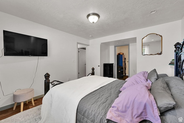 5443 S 4175 W, Roy, UT 84067 - bedroom featuring a textured ceiling, wood finished floors, and baseboards