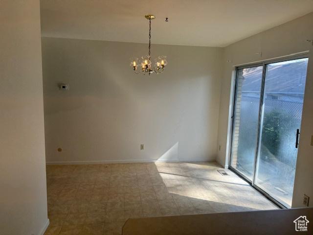 3165 S Green St, Salt Lake City, UT 84106 - spare room with a chandelier and baseboards