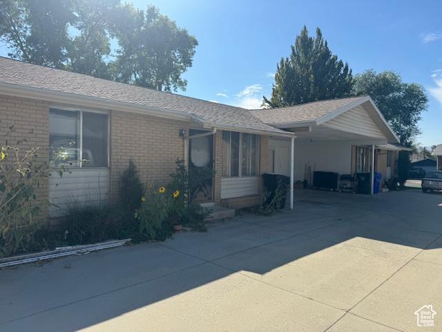 3165 S Green St, Salt Lake City, UT 84106 - ranch-style house featuring brick siding, concrete driveway, and an attached carport