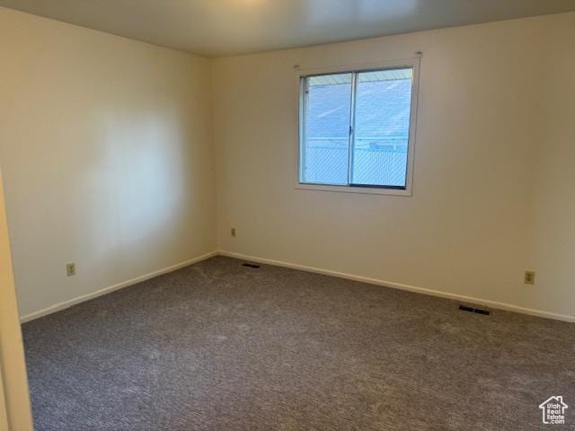 3165 S Green St, Salt Lake City, UT 84106 - empty room featuring dark carpet and baseboards