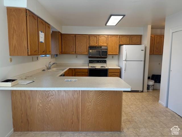 3165 S Green St, Salt Lake City, UT 84106 - kitchen with freestanding refrigerator, black microwave, electric range, a sink, and a peninsula