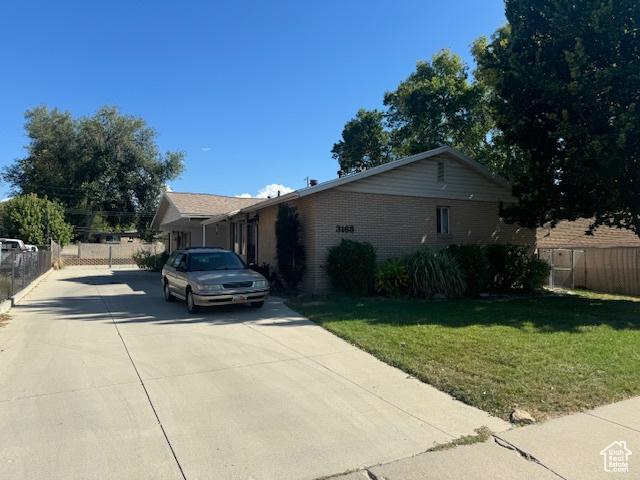 3165 S Green St, Salt Lake City, UT 84106 - view of front of home with concrete driveway and brick siding