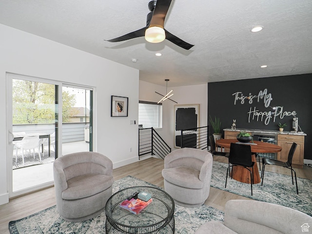 4535 S Bleecker Pl, Millcreek, UT 84117 - living room featuring light wood-style flooring, a ceiling fan, recessed lighting, baseboards, and beverage cooler