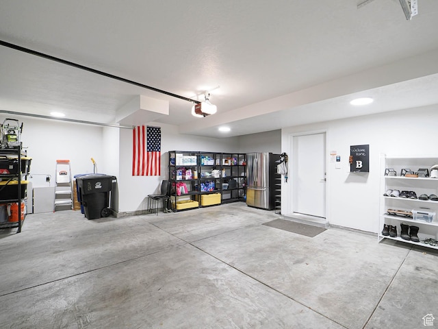 4535 S Bleecker Pl, Millcreek, UT 84117 - garage with freestanding refrigerator, a garage door opener, and recessed lighting