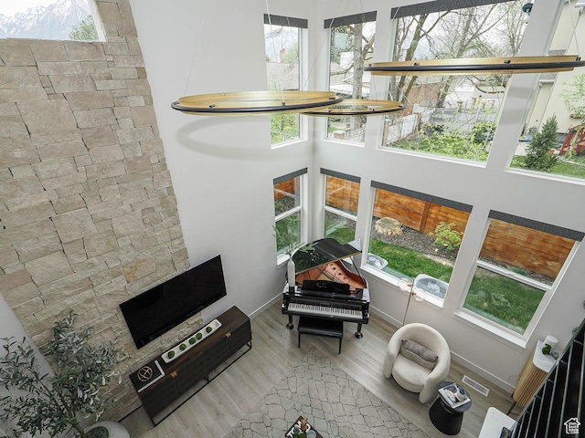 4535 S Bleecker Pl, Millcreek, UT 84117 - living area with wood finished floors, a high ceiling, and baseboards
