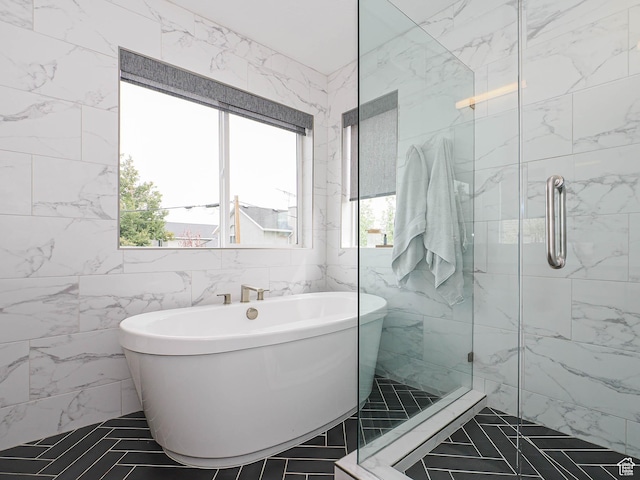 4535 S Bleecker Pl, Millcreek, UT 84117 - bathroom featuring healthy amount of natural light, tile walls, a freestanding bath, and a shower stall