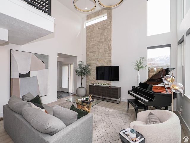 4535 S Bleecker Pl, Millcreek, UT 84117 - living room featuring a towering ceiling, wood finished floors, and baseboards