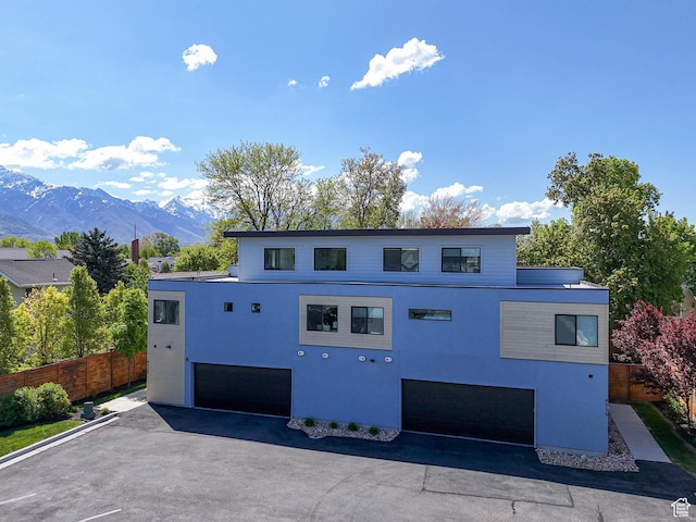 4535 S Bleecker Pl, Millcreek, UT 84117 - view of front of home featuring an attached garage, a mountain view, and stucco siding
