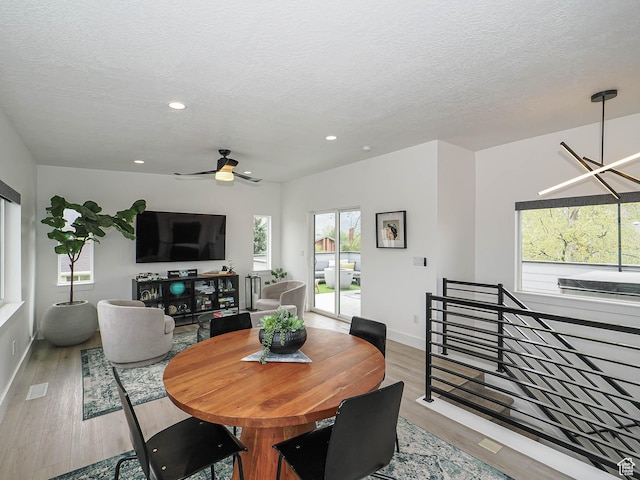 4535 S Bleecker Pl, Millcreek, UT 84117 - dining area featuring wood finished floors, a ceiling fan, a textured ceiling, recessed lighting, and baseboards