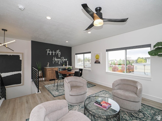 4535 S Bleecker Pl, Millcreek, UT 84117 - living room featuring light wood-type flooring, a textured ceiling, ceiling fan, baseboards, and recessed lighting