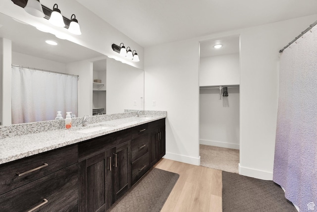 1279 S 50 E, Salem, UT 84653 - bathroom featuring wood finished floors, double vanity, a spacious closet, baseboards, and recessed lighting